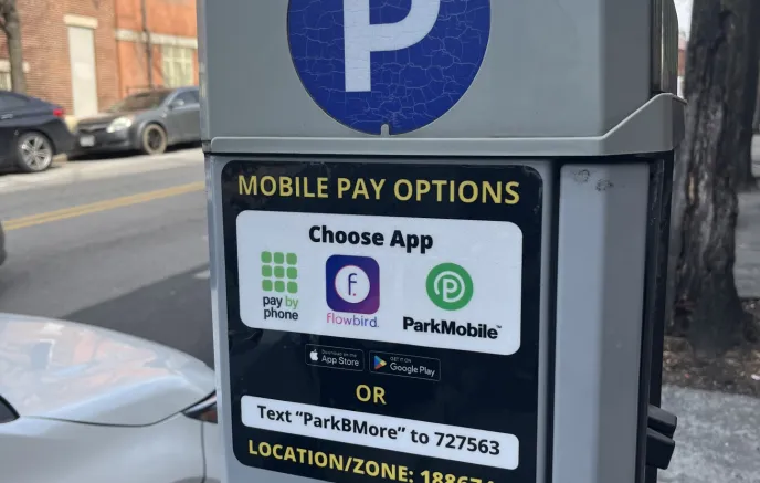 side of parking meter kiosk with decals