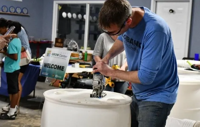 man working at a GROW event