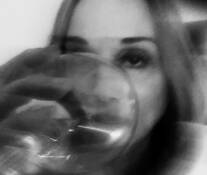 Woman Glaring Through Wine Glass by Lloyd Segal