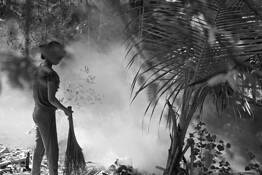 Girl Burning Trash by Lee Grossman