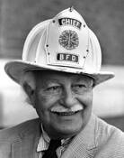 Arthur Fielder Showing Off One of His Fire Helmuts by James R. Holland