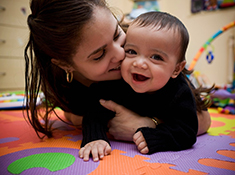 Woman hugging infant