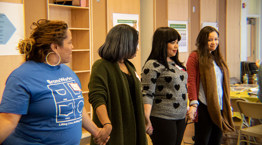 Participants at a PD session holding hands in a line