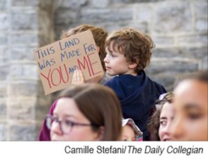 Child holding patriotic sign during protest
