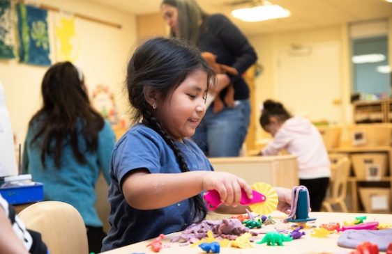 Child works with clay at Bank Street Head Start