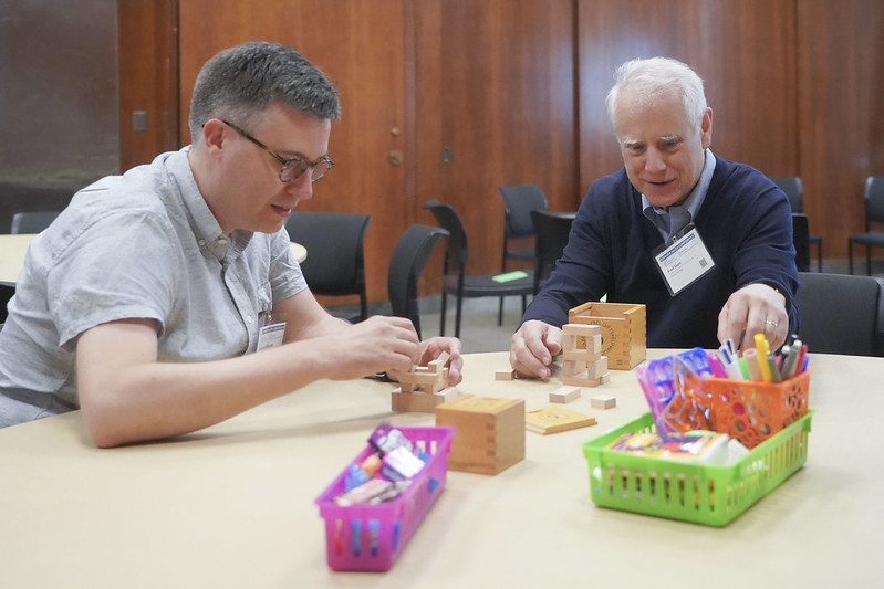 Two educators participate in conference workshop