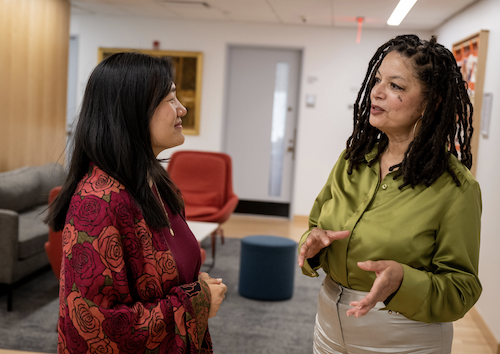 Teacher and grad student talking in hallway