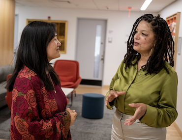 Teacher and grad student talking in hallway