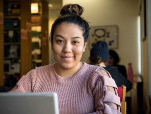 Graduate student at a computer in the library