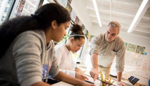 Teacher working with two students