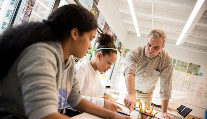 Teacher working with two students