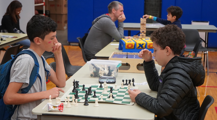 Students playing chess at the Fall Fair 2022