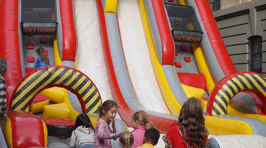 Children lined up for inflatable slide at the Fall Fair 2022