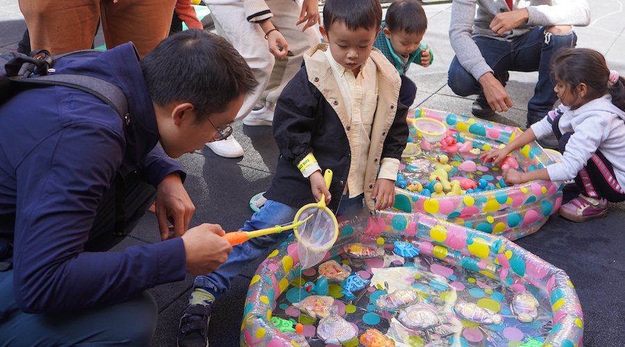 Parents and children playing water games at the Fall Fair 2022