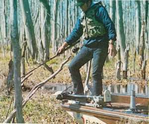 Spencer dipping his long spinning rod rigged with a crappie jig in the Rodman Pool weeds. Photo 1976 May/June issue of Bassmaster Magazine.