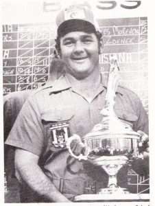 Ricky Green holds his second 1st-place Bassmaster trophy from his win on Sam Rayburn in 1974. Photo May/June 1974 issue of Bassmaster Magazine.