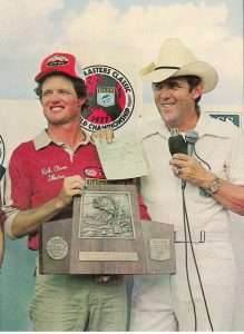 Rick Clunn holds his second Bassmaster Classic trophy in two years. Photo Bassmaster Magazine.