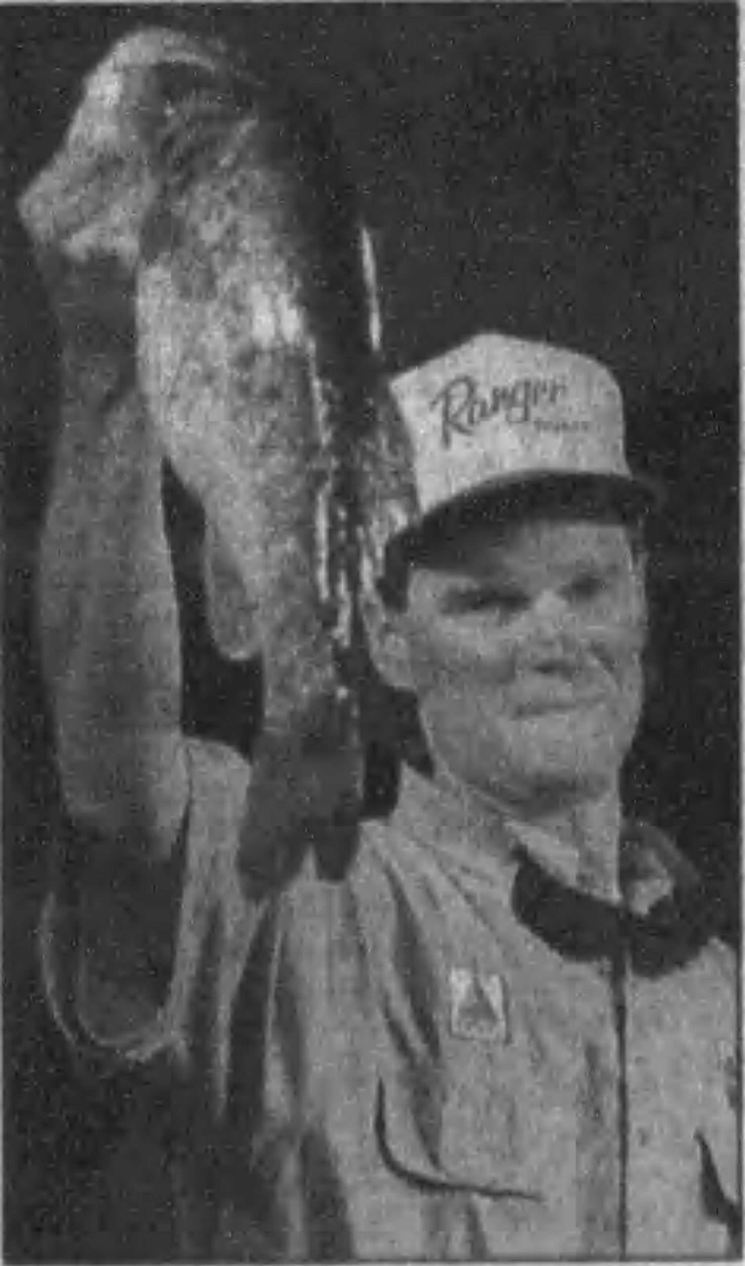 Newell_Jan_1999 Original Caption: BIG CATCH: Rob Newell hoists a lunker bass on stage in Clewiston as he wins the co-angler title. January 1999, News-Press, photo credit: Mark Hume/News-Press.