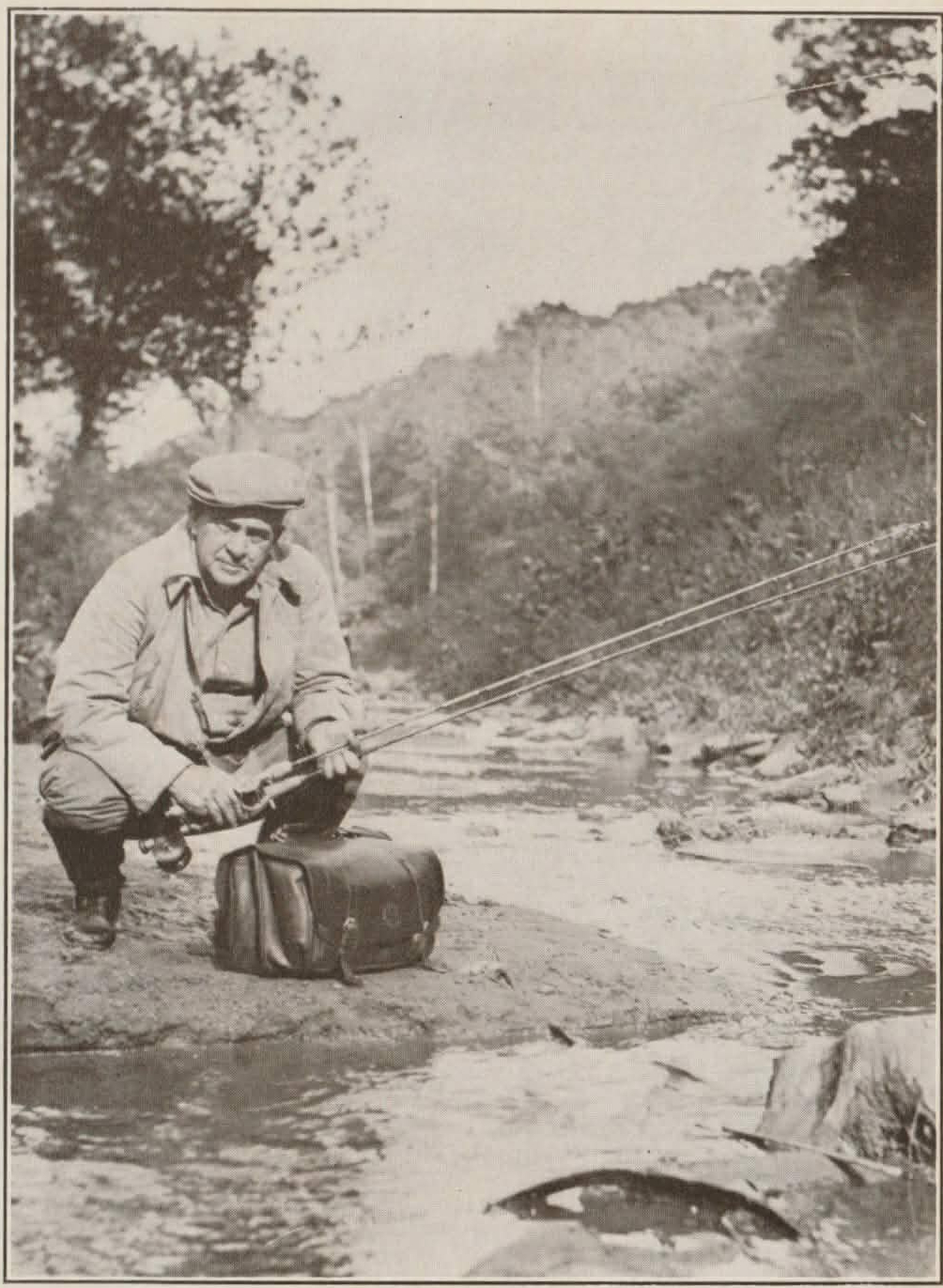 My Friend the Black Bass, 1930, interior photo of Harry Hawes at streamside. In this, the only illustration in the book, Hawes holds his usual gear, a fly rod and a baitcasting short rod. Original caption: "The Senator, ready for the contest, with both short and long rods, and his bag equipped."