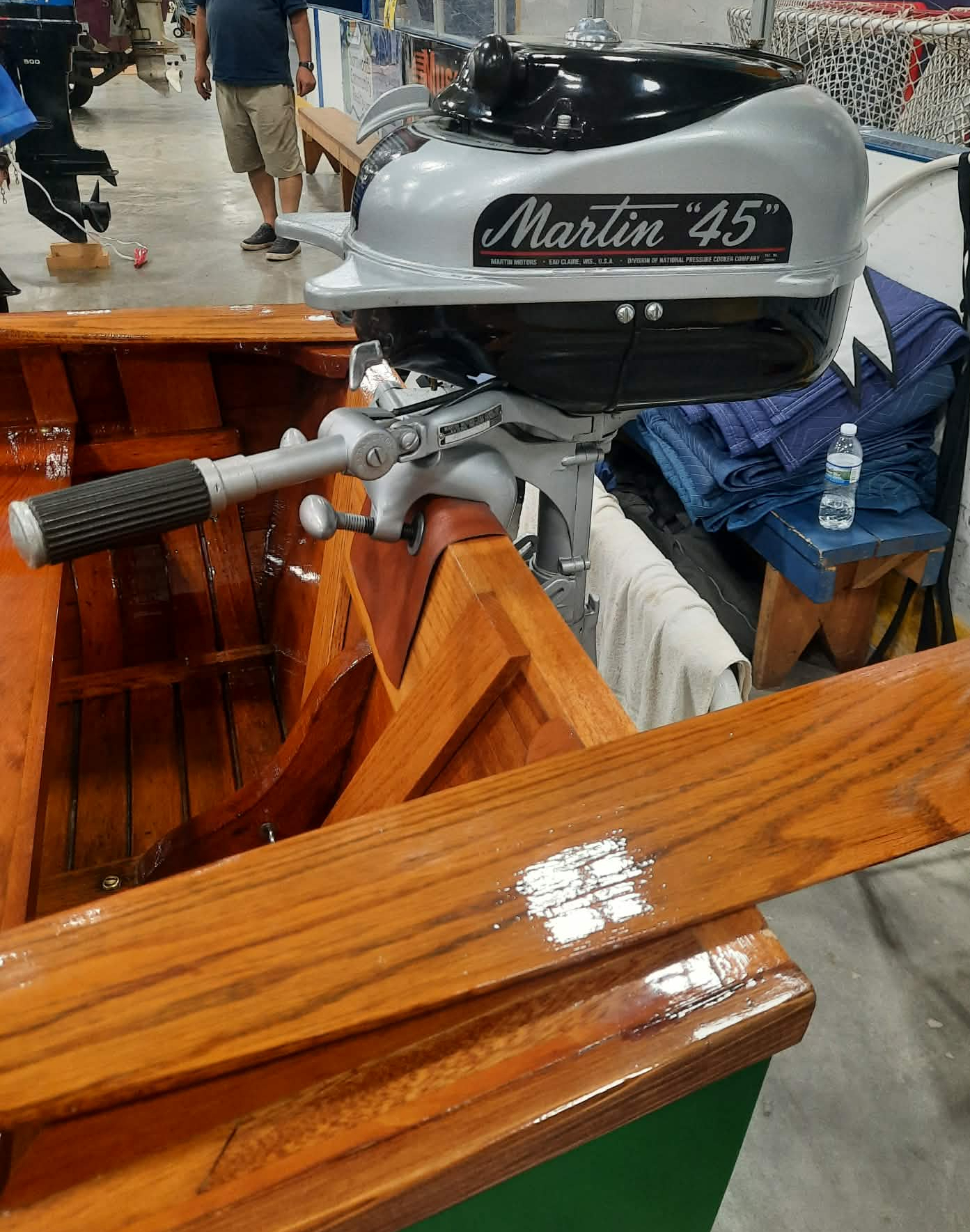 Restored Martin 45 outboard motor on mahogany transom of Shell Lake Snipe Guide boat.