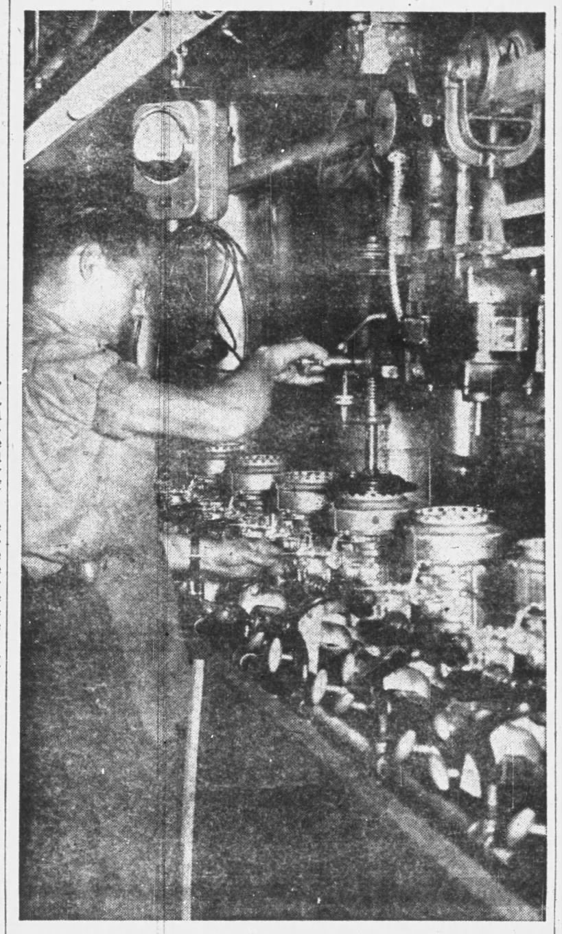 Original caption: A small section of the testing department, where the motors are tested out in tanks under conditions comparable to what they will undergo in actual use, is shown here with Ed Hatli about to start one of them spinning. Eau Claire Sunday Leader, Eau Claire, Wisconsin, Sunday, October 19, 1947.