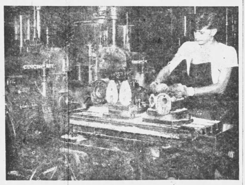 Original caption: George Ayres is here mounting two intermediate housing parts of a Martin motor on a Cincinnati milling machine preliminary to running them through the machining process. Four parts can be machined in one operation on this massive piece of equipment. Eau Claire Sunday Leader, Eau Claire, Wisconsin, Sunday, October 19, 1947.
