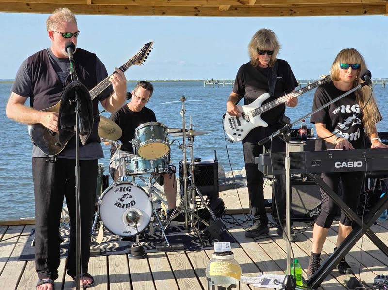 KG Band performing live outside on a dock