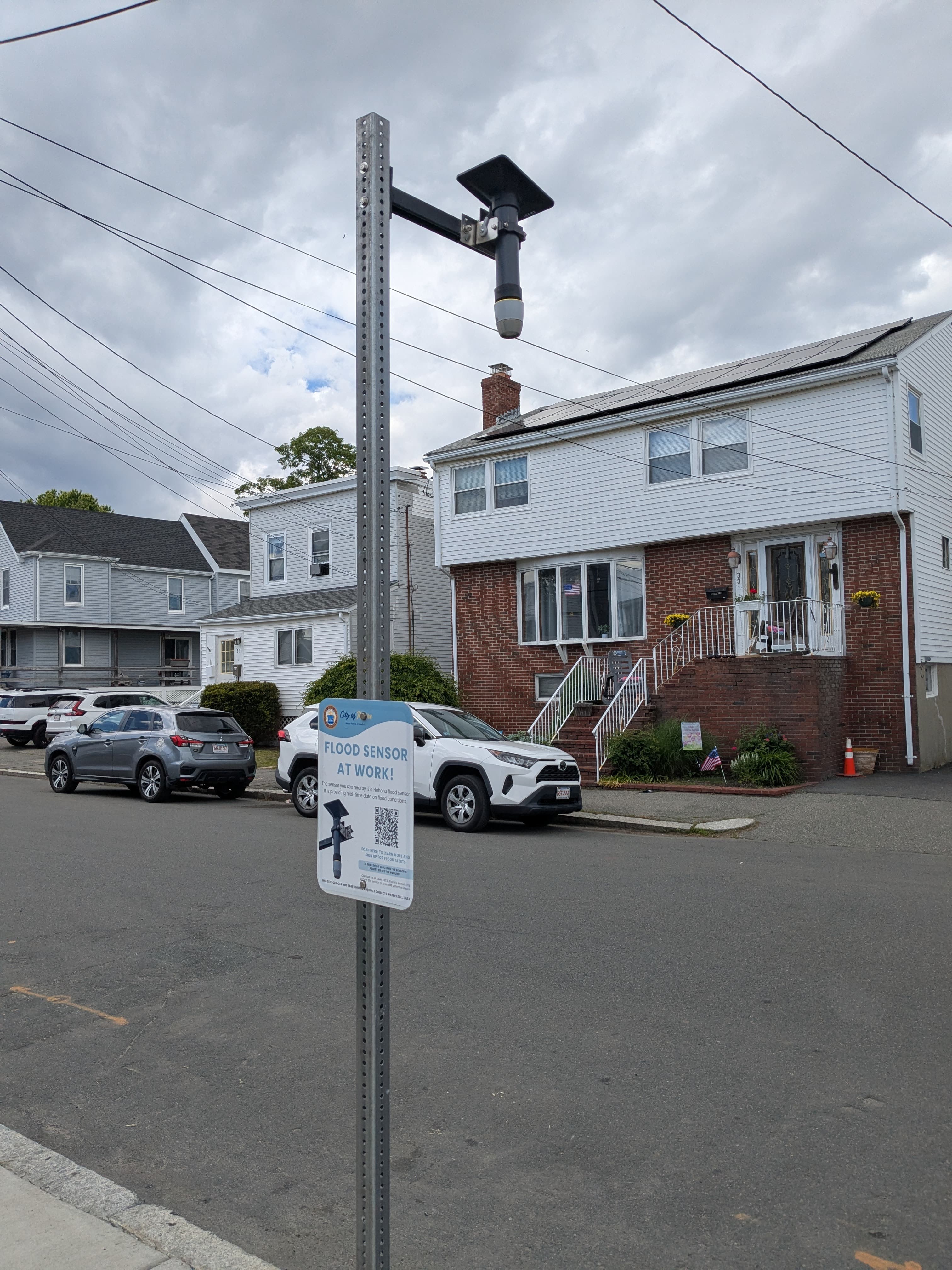 Flood sensor on pole in residential neighborhood