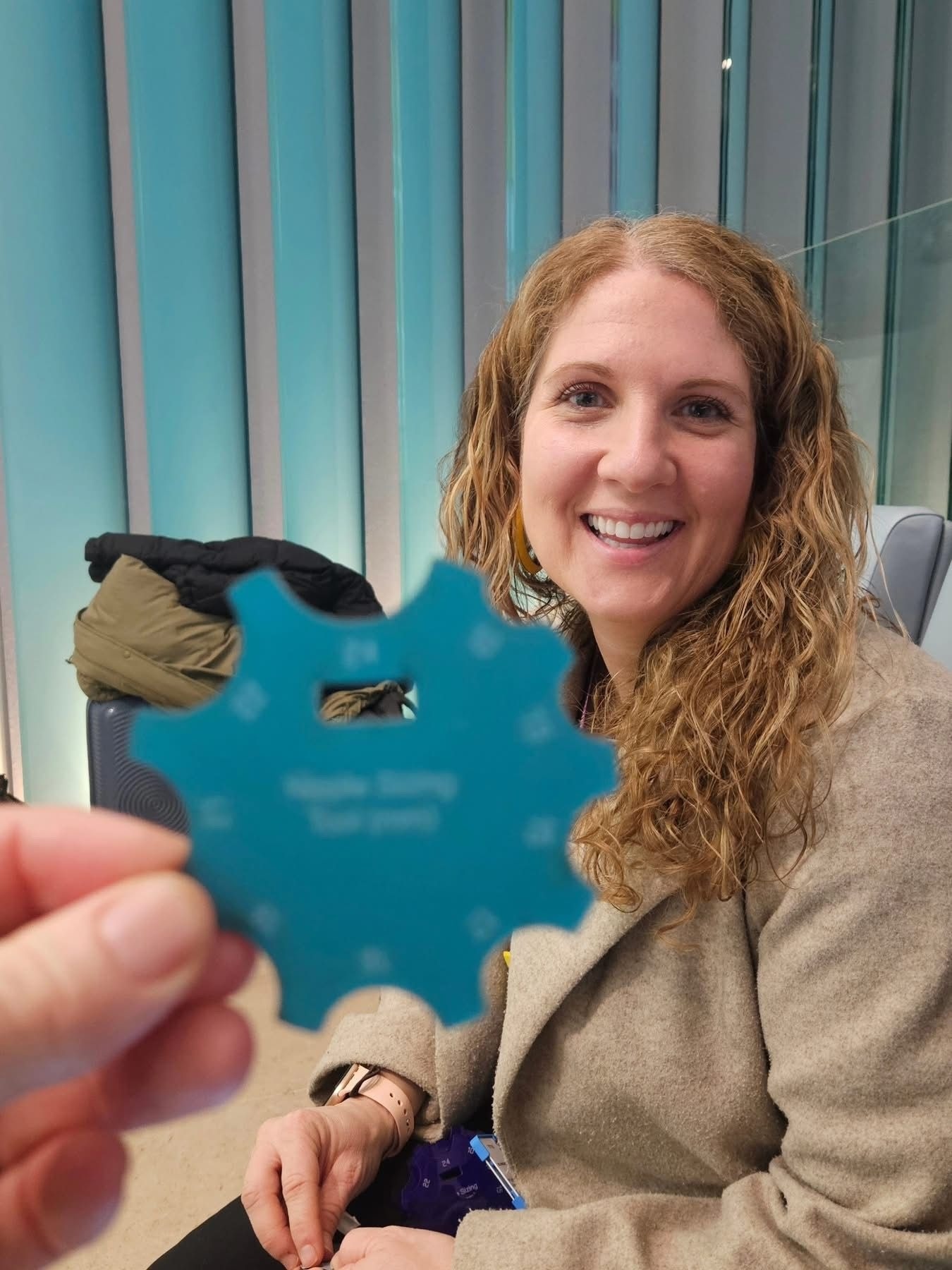 Amber Clark with a blue nipple measurement tool