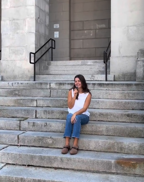 woman sitting on marble stairs