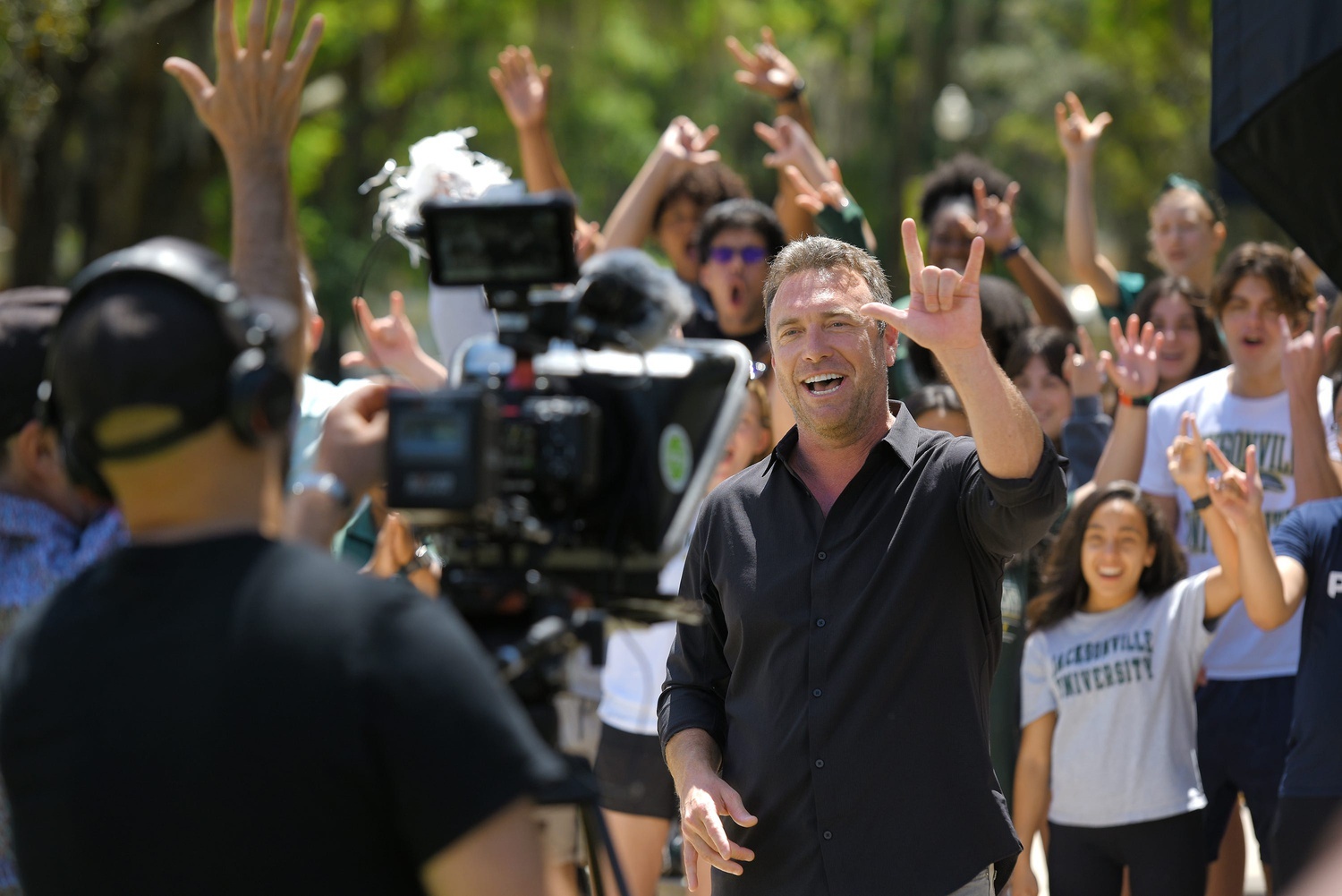 Phil Keoghan, host of the Amazing Race, filming with group of kids