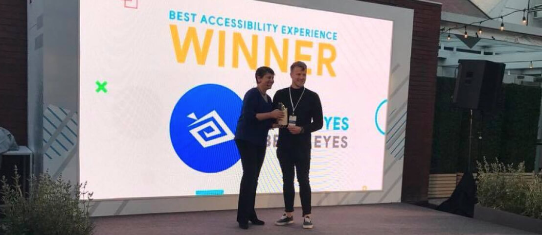 Be My Eyes Community Director, Alexander, accepting the Google Play award on stage.