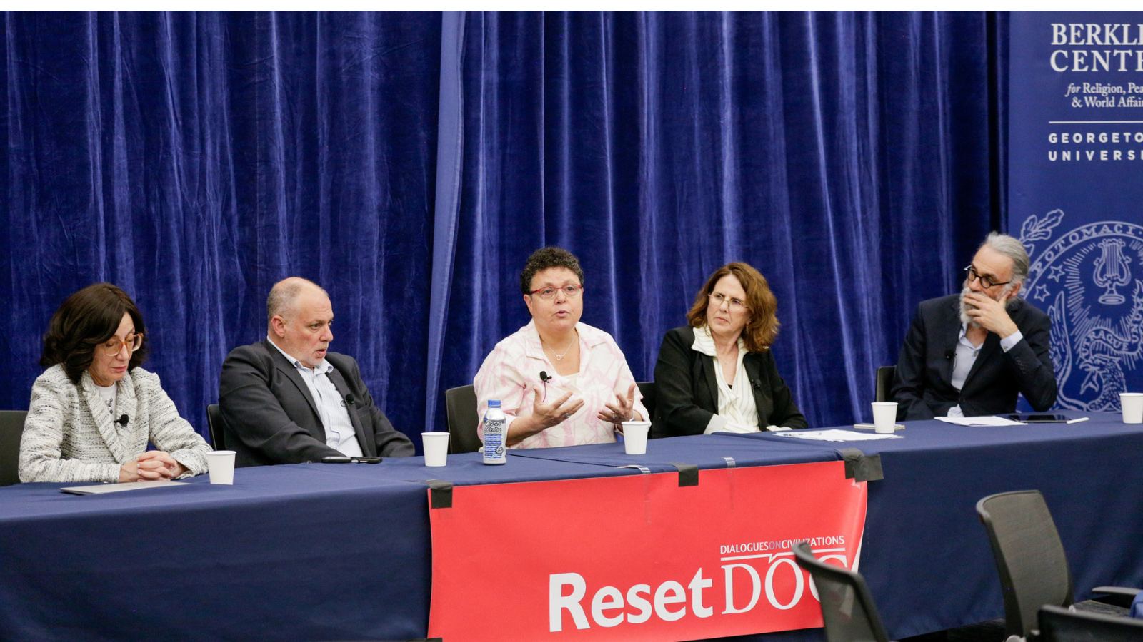 Ronit Irshai (center), research fellow at Shalom Hartman Institute in Jerusalem, speaks as other panelists look on.