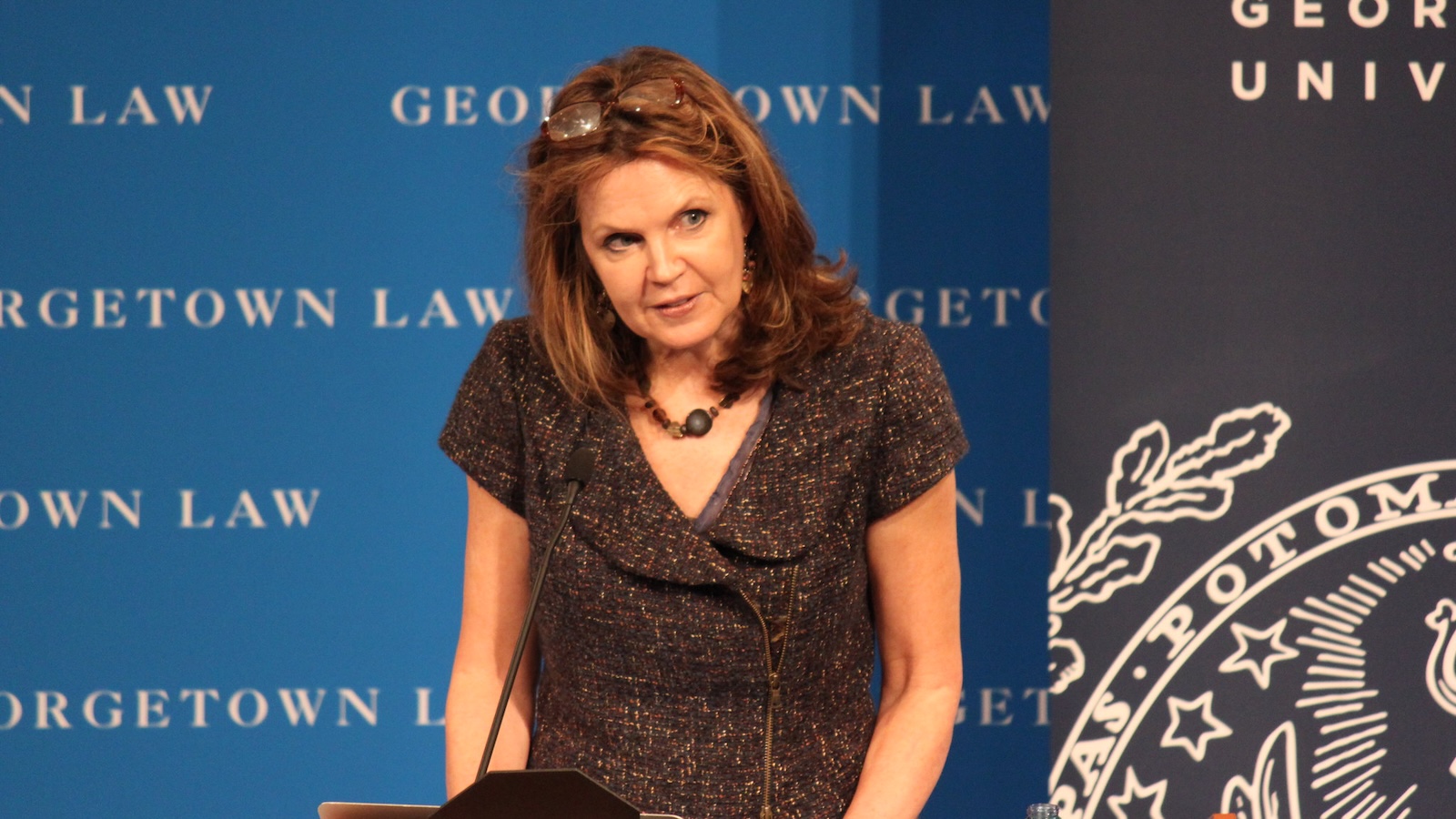 Tracy Fessenden speaks at a podium to introduce panelists.