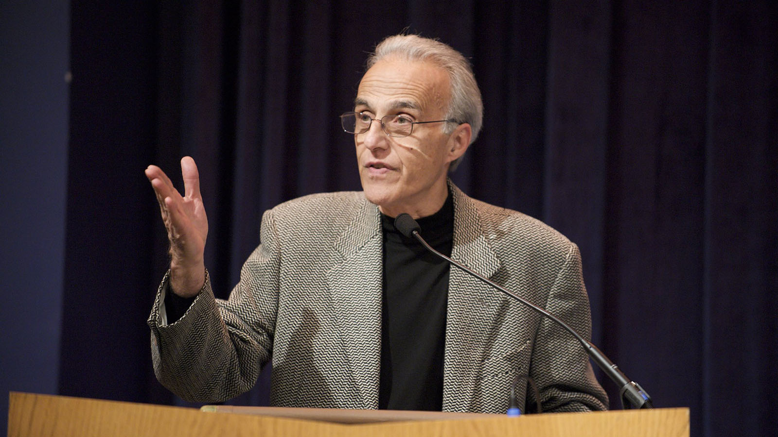 John Esposito stands in front of a podium