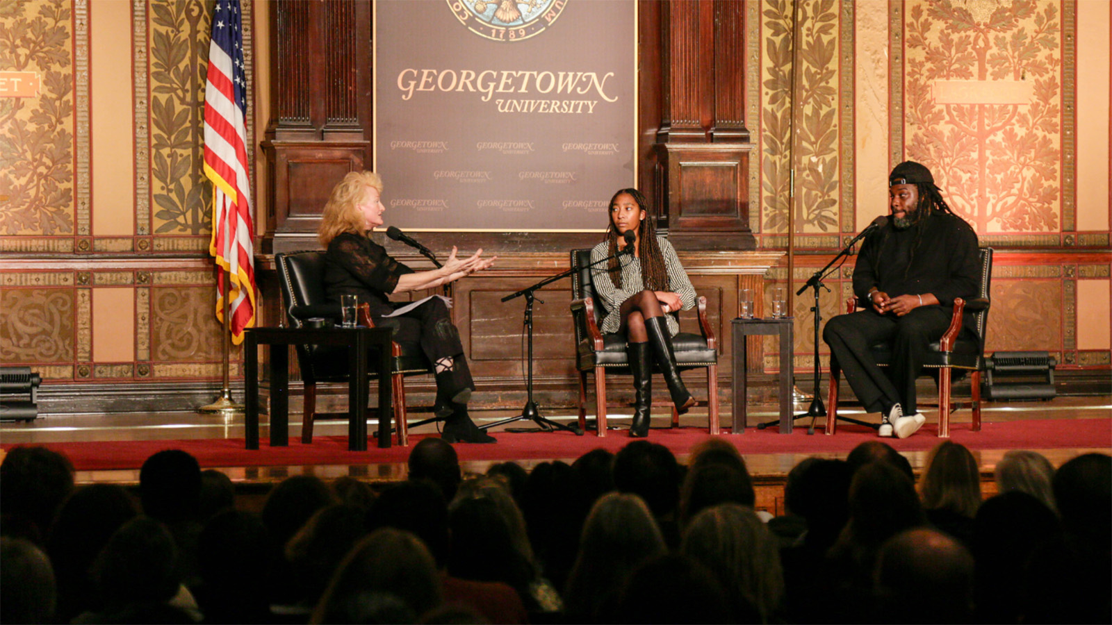 Krista Tippett, Kessley Janvier (C'25), and Jason Reynolds on stage in Gaston Hall