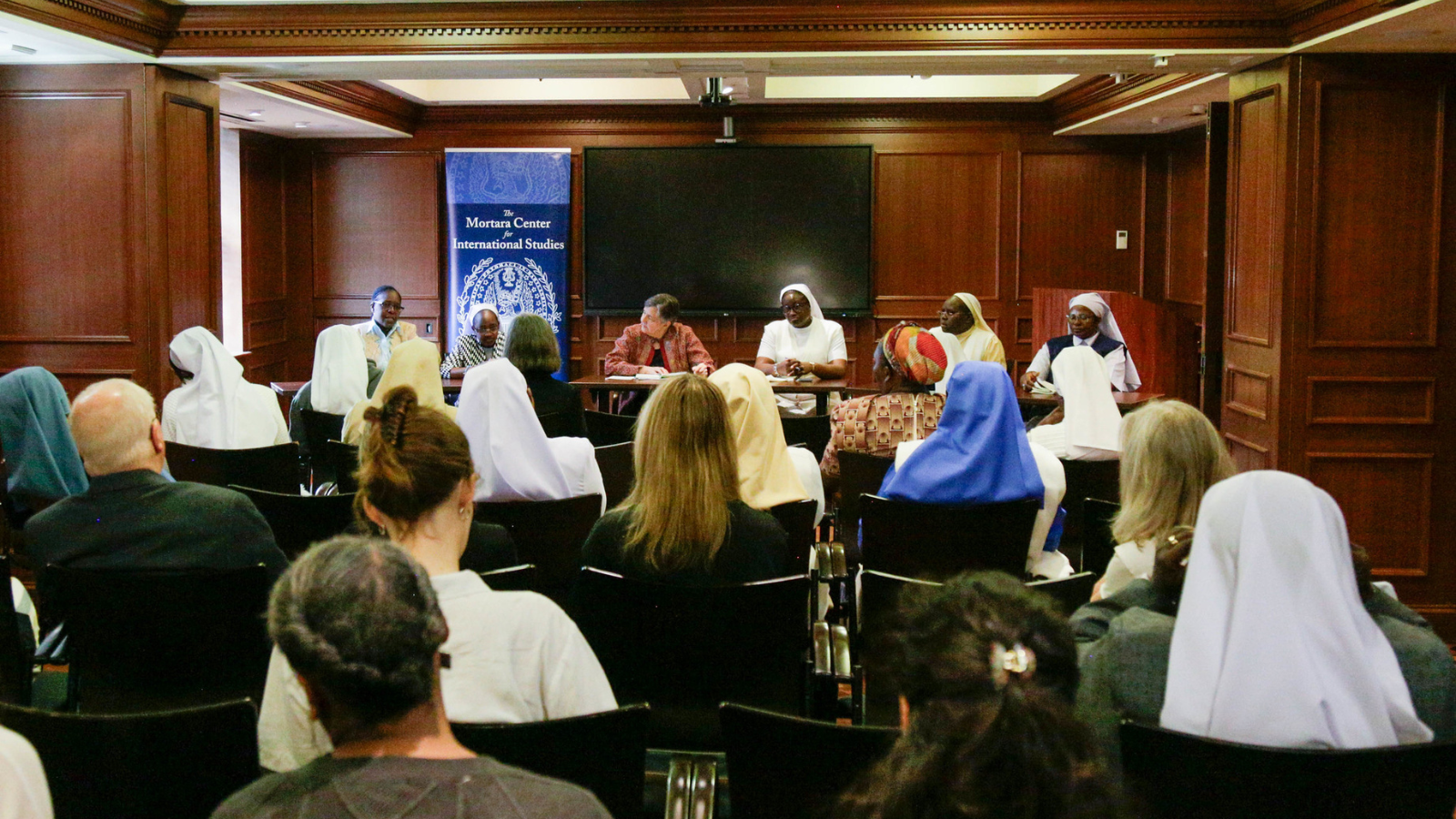 A panel of African Catholic sisters face an audience in the Mortara Conference Room