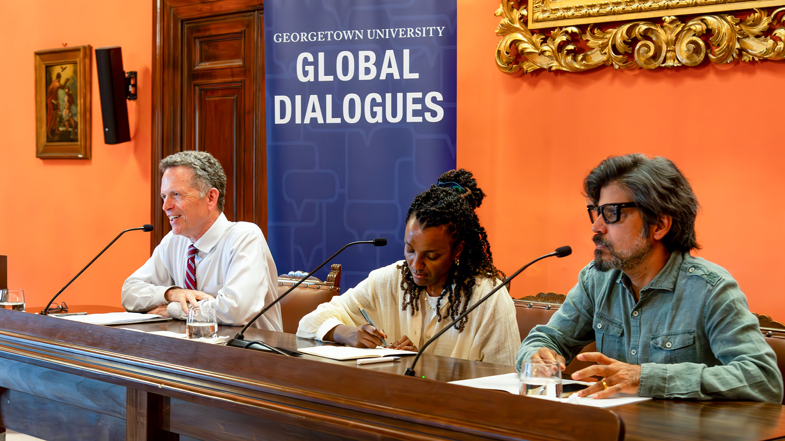 Thomas Banchoff speaking from a table alongside Nesrine Malik and Pankaj Mishra
