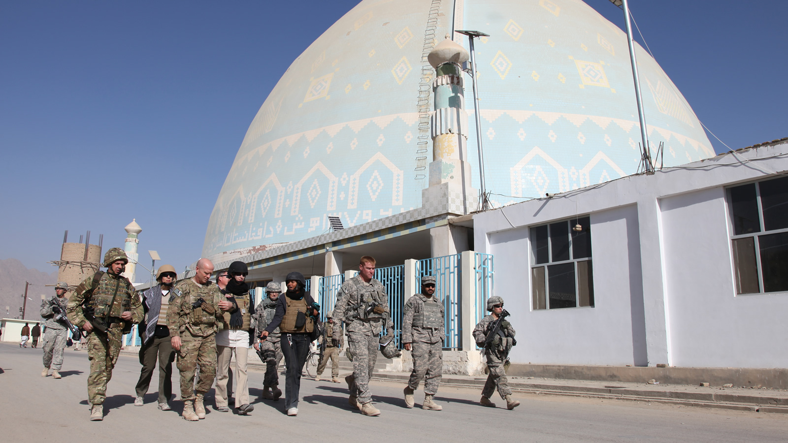 A Multinational Group of Soliders Walks in Front of a Mosque in Kandahar, Afghanistan