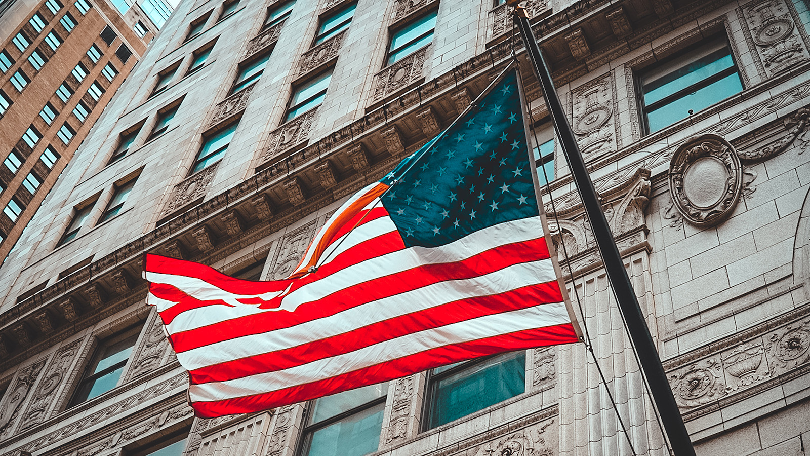 American flag flying outside a building.