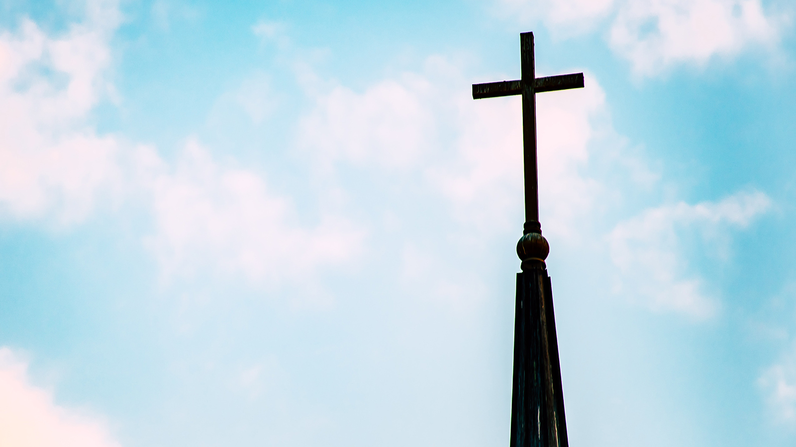 A church steeple against a blue sky.
