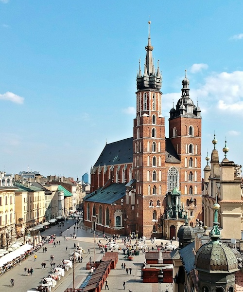 A distant view of a street and a church in Poland