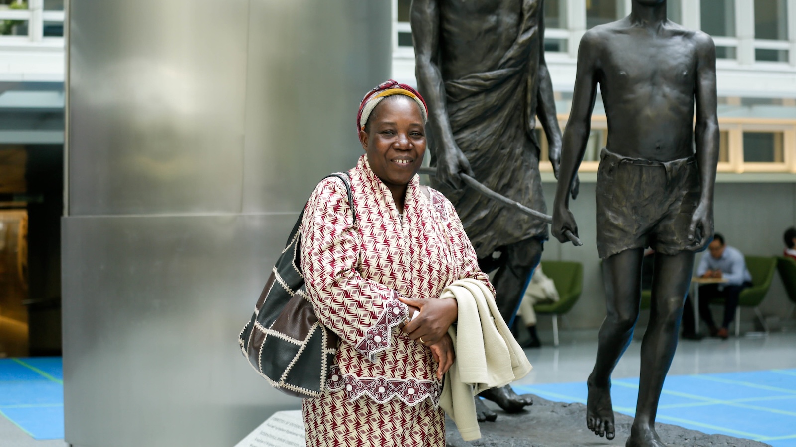 Sr. Georgette, SDD,  standing in front of a statue at the World Bank