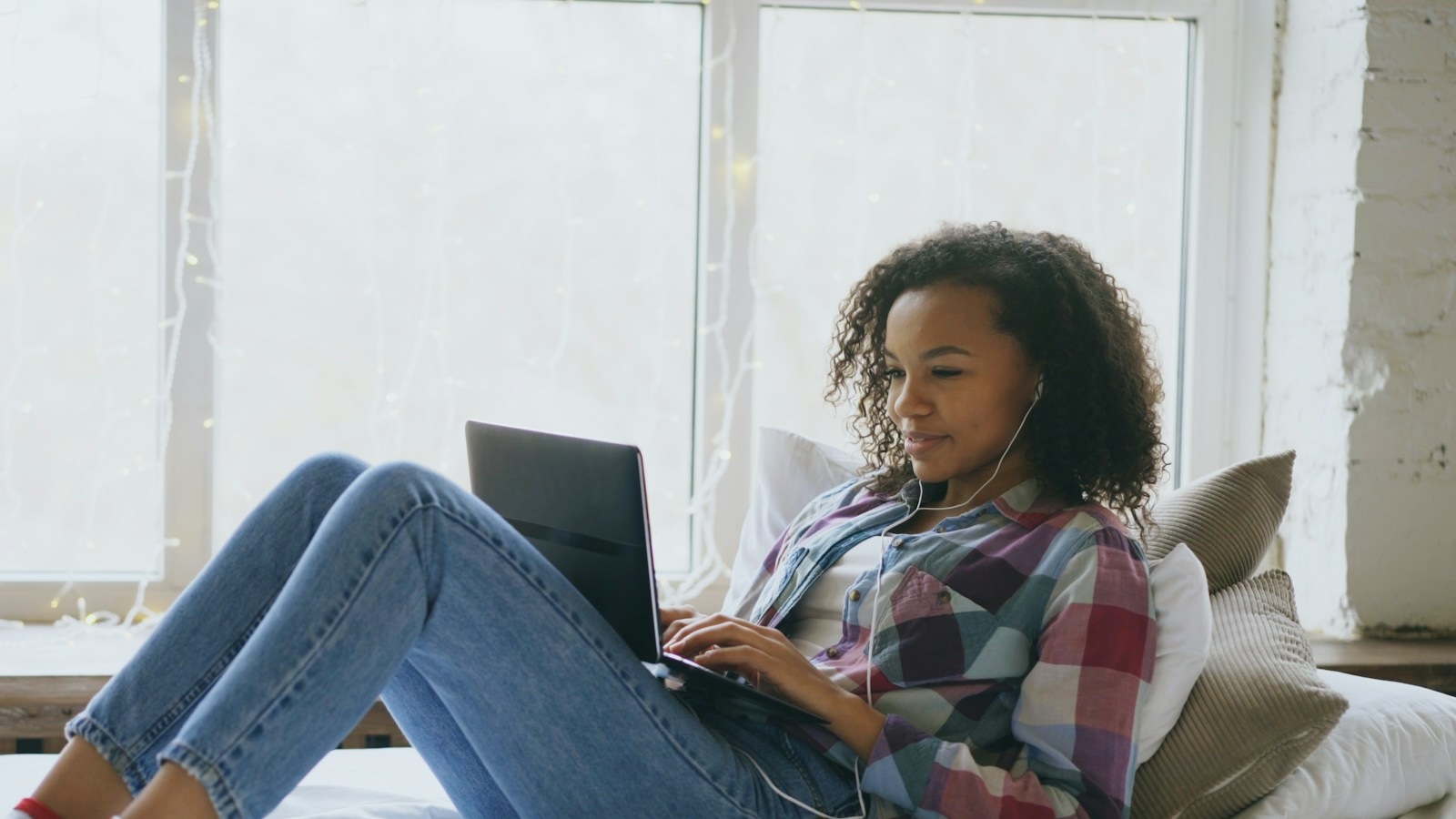 A student using a computer with headphones in