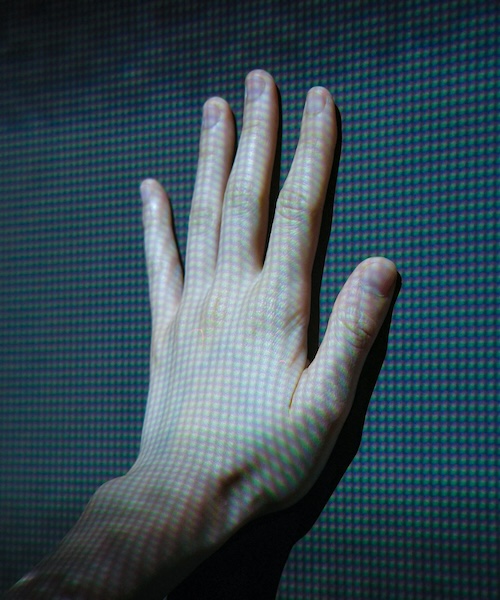 Human hand touches a screen with light points