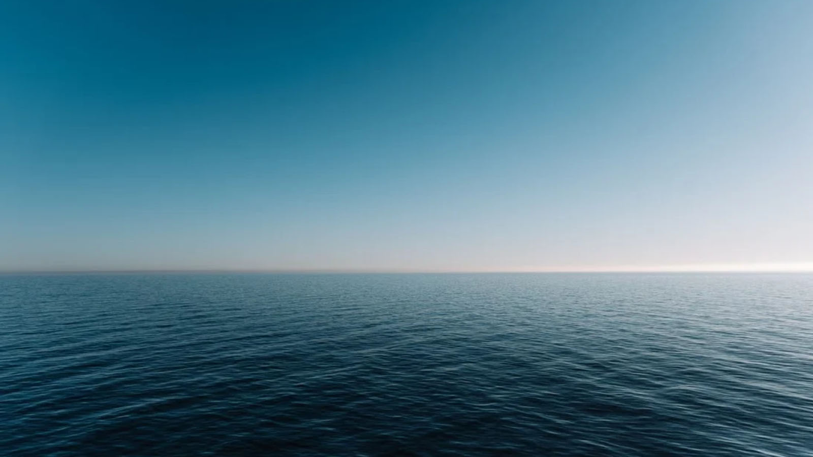 Horizon where vast blue ocean meets vast blue sky