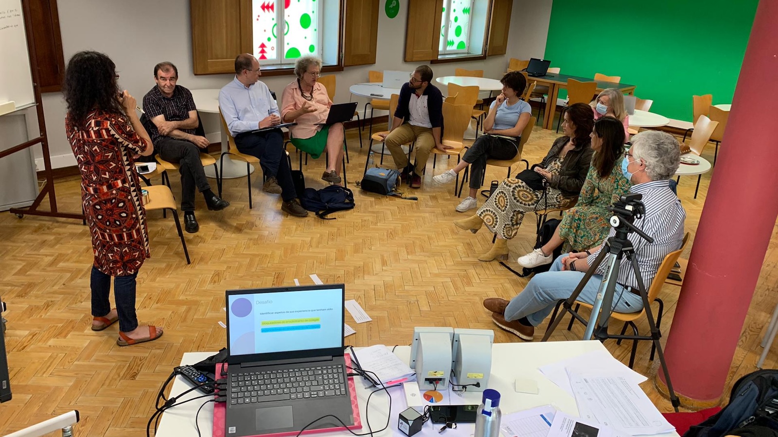 People seated in a semi-circle being led in a workshop