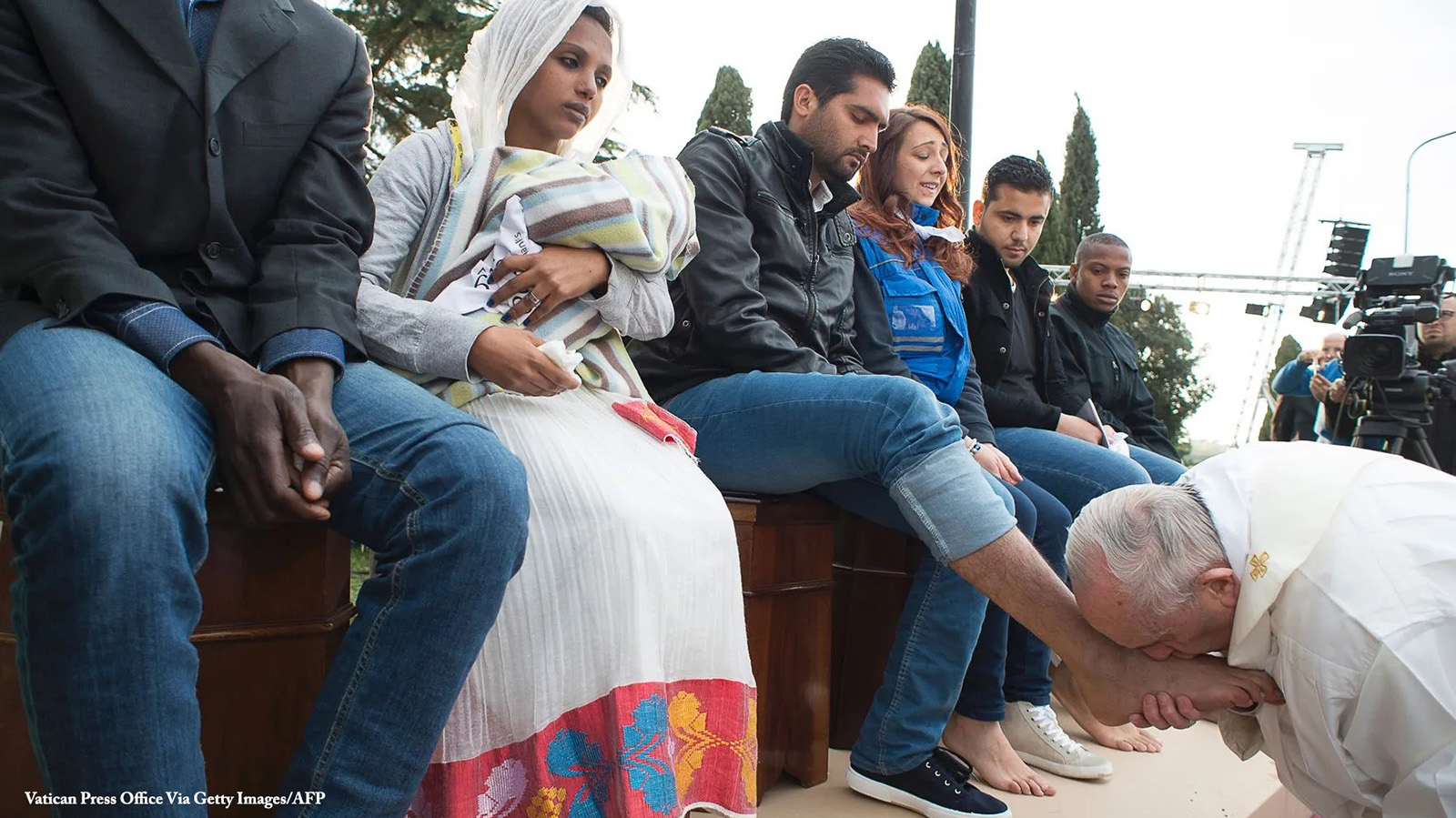 Pope Francis washing the feet of migrants in Rome. Photo from Vatican Press Office Via Getty Images/AFP.