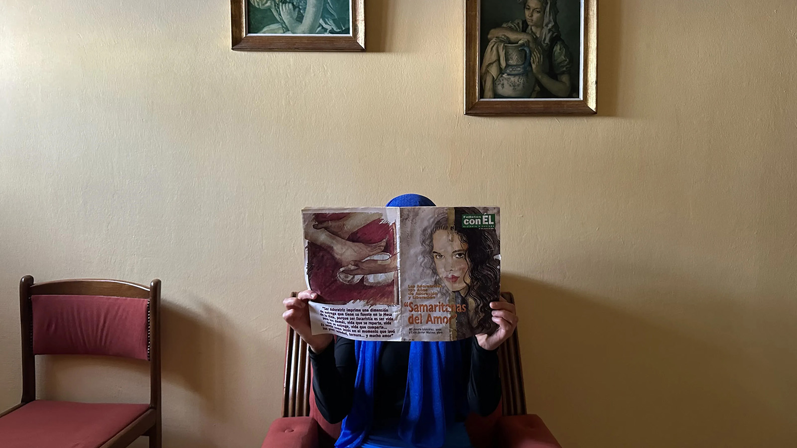 A woman in a headscarf reads a magazine in a convent in Spain