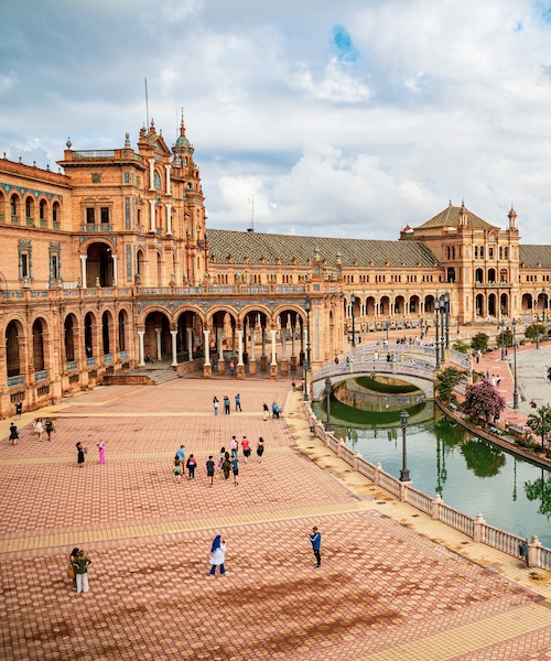 People walking along a river in Spain